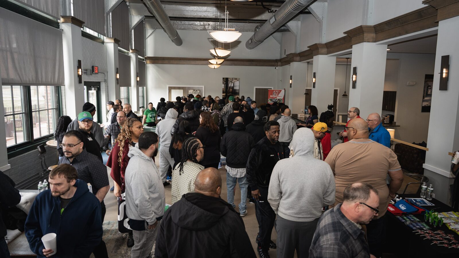 Community members gathered around SCRIP outreach tables