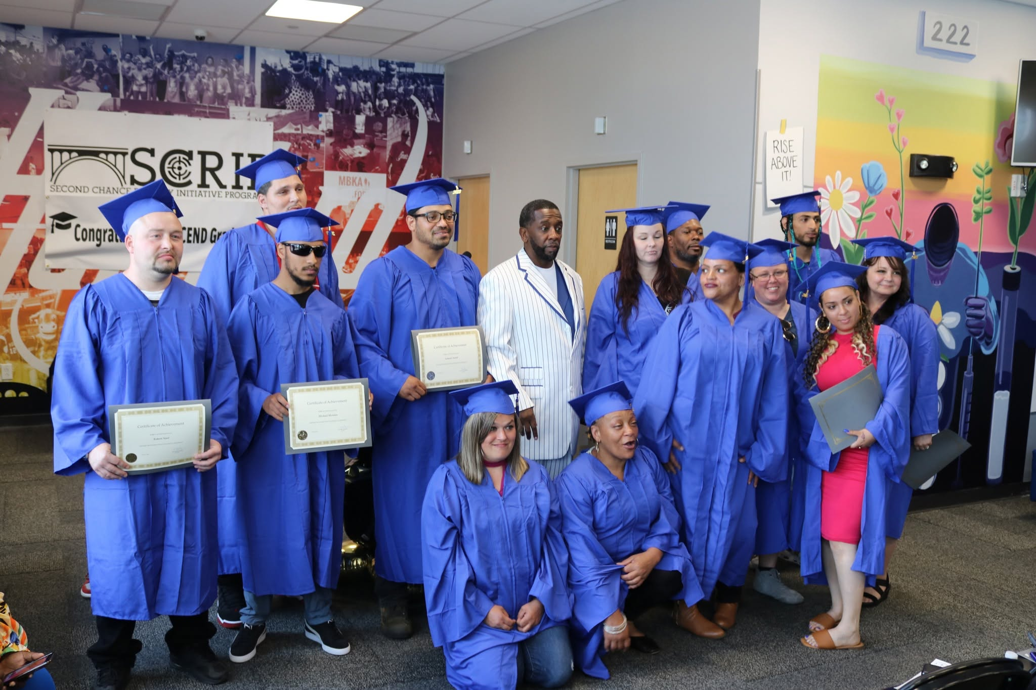 SCRIP graduates in blue caps and gowns celebrating their achievement