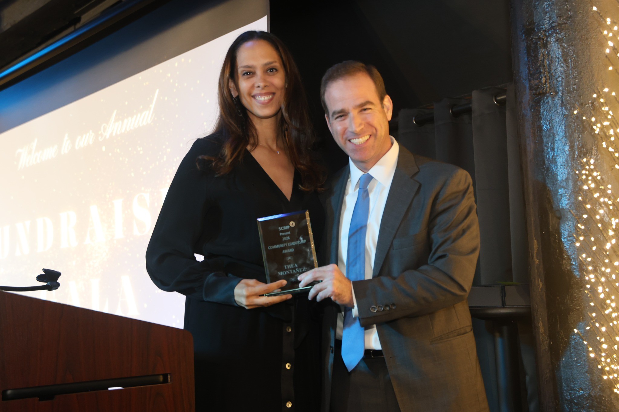 Thea Montañez receiving an award from former Hartford Mayor Luke Bronin
